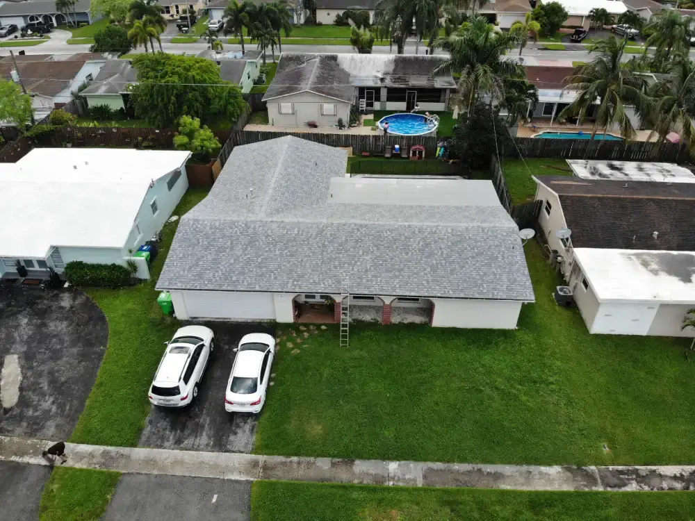 Aerial view of a Coral Springs, Florida neighborhood with a roof replacement in progress